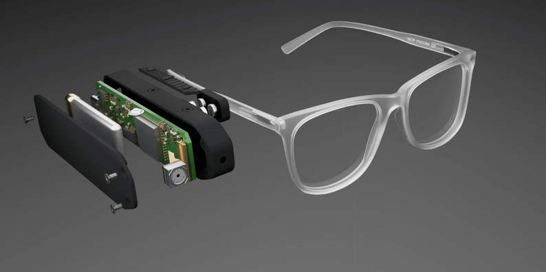 ExploraVist Device attached to glasses showing the camera, speaker, and microphone components